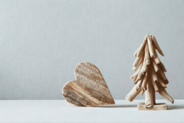 Rustic wooden heart and christmas tree duo on a white surface