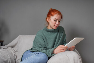 young woman reading ebook at home