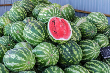 Pile of watermelons with one cut in half