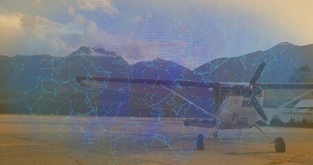 Single-engine propeller airplane displaying digital overlay on tarmac by water, with blue network