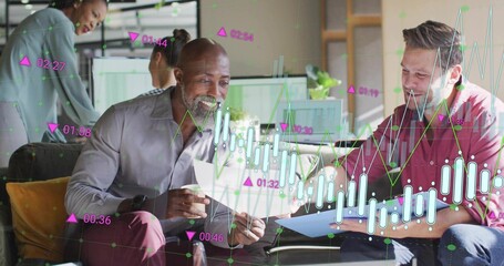 Reviewing printed documents mature adult man sitting on sofa in office lounge, with data overlays