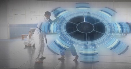 Sparring fighters in uniforms and colored belts engaging strikes in dojo, with digital HUD overlay