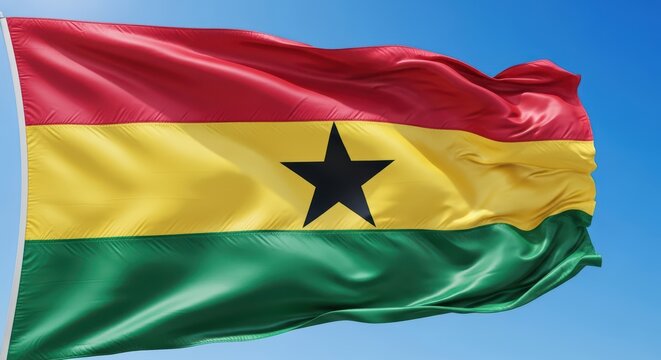 Ghana national flag waving against clear blue sky - Powered by Adobe