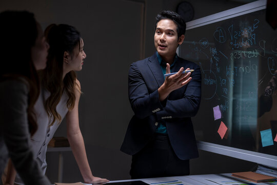 Business team planning strategy late night in office