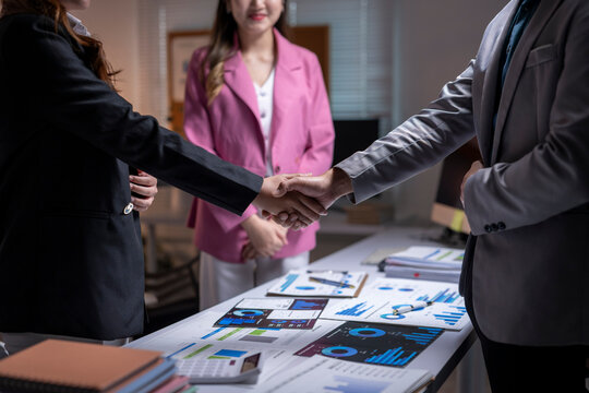 Business partners shaking hands making deal in office