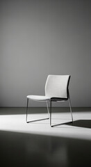 Obraz premium A single modern chair sits alone under a spotlight in an empty room