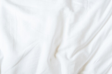 White bedsheet background, bed sheet cotton fabric texture, wrinkled duvet, crumpled satin blanket comforter cloth used in hotel, resort or home interior for bedding sleep comfort