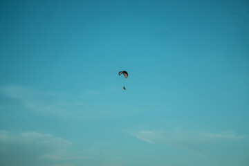 Paraglider Soaring Alone Against a Clear Blue Sky