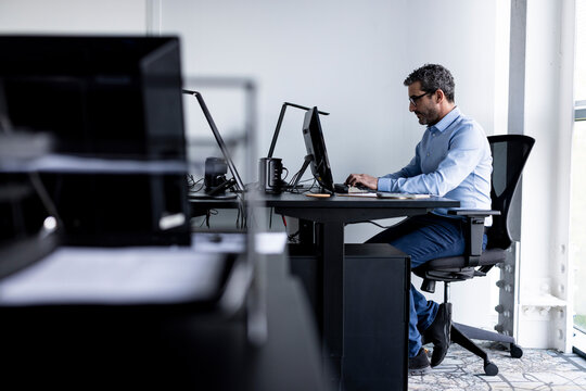 Businessman working on desktop PC in office