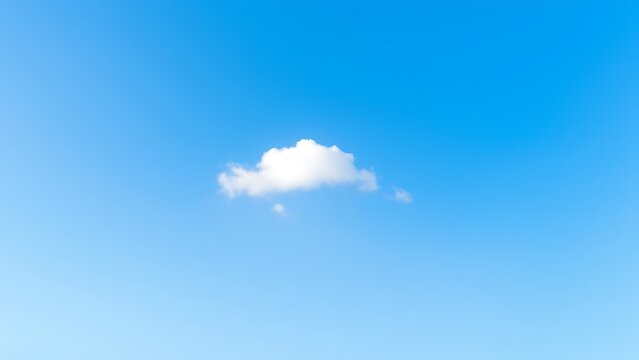 A solitary white cloud drifting across a clear blue sky, embodying simplicity and peace.