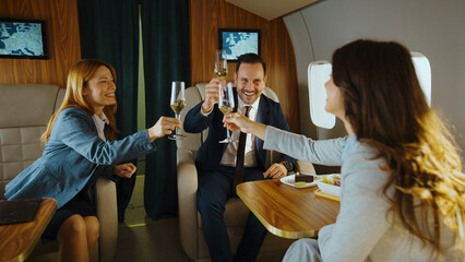 Business people raising champagne glasses smiling and cheering, celebrating professional success,...