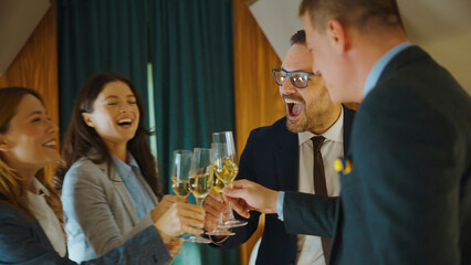 Business colleagues toasting with champagne glasses, celebrating professional success and teamwork with happy expressions during a corporate event or office party