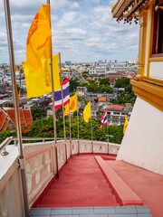 The red staircase leading up and down Golden mountain ( Phu Khao Thong) at Wat Saket one of Bangkok's most iconic landmarks, is popular among international tourists visiting Bangkok, Thailand.