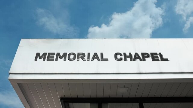 A memorial chapel word sign displayed on a serene religious building under a clear blue sky, symbolizing remembrance, spiritual solace, and sacred tributes