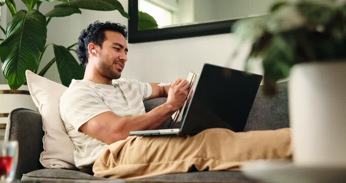 Earphones, laptop and notebook with student man in home living room for learning or study. Audio course, computer and writing with person in apartment for online college or university education