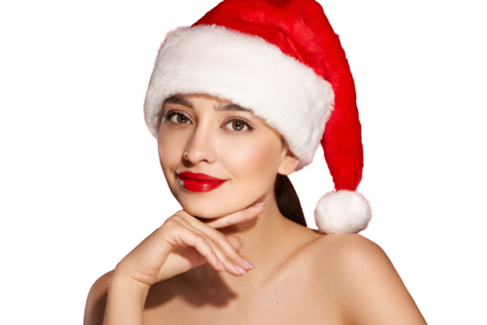 Christmas Woman. Beauty Model Girl in Santa Hat over transparent Background. Holiday makeup. Red Lips and Manicure. Beautiful Holiday Makeup