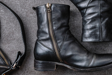 Side Zip Boots and Accessories on Concrete © KenamiRyoko