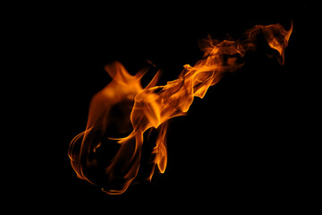 Blazing fire and glowing flames on a dark background perfect for creative design and visual effects.
