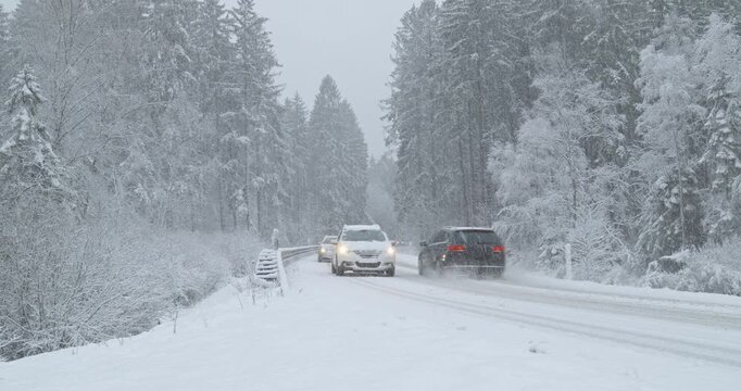 Winter Driving - Cars on a Snowy Mountain Road in Heavy Snowfall