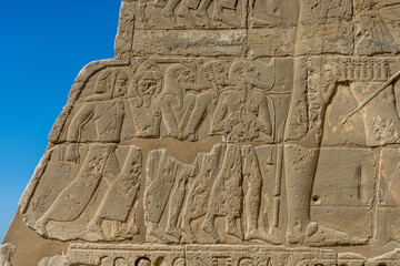 Weathered Relief Carving of Figures on Ancient Egyptian Temple Wall