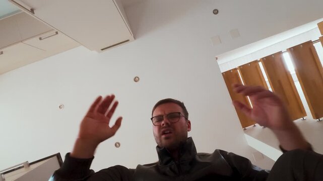 Point-of-view shot of a man opening a cardboard box, first surprised and then visibly disappointed and angry at the contents. Perfect for e-commerce, delivery failure, or customer reaction themes.