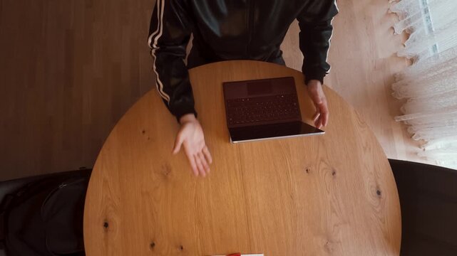 A real estate agent sits at a wooden table with a laptop, red folder, and key, reviewing documents. Perfect for housing, property sales, rentals, insurance, or mortgage business themes.