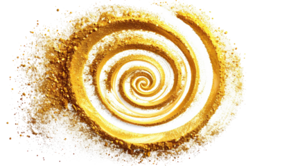 Golden spiral of fine powder, shimmering and dissolving