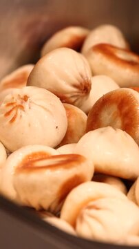 Close-up of golden fried dumplings, mini gyoza, Guo Tie, or Gun Mandu served on a plate, showcasing crispy texture, Asian street food, and delicious snack ready to eat.