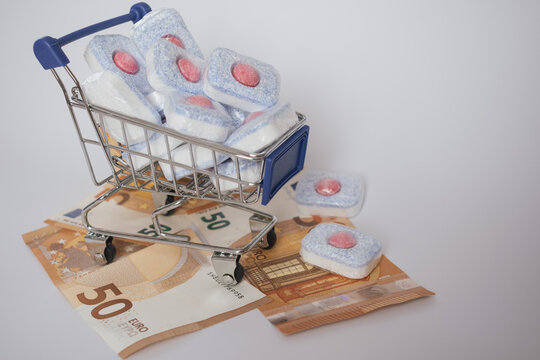 Cost of living: expensive dishwasher tablets next to euro currency, showing household expense - Powered by Adobe