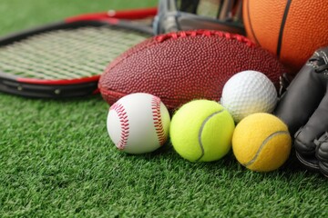 Sports equipment arranged on green grass showcasing various athletic gear for outdoor activities throughout the day