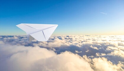 Blue sky view of an airplane wing flying through soft clouds on a transport flight