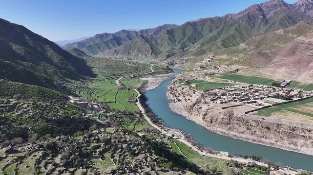 Asmar District, Kunar river valley drone aerial with beautiful Hindu Kush mountains, forests and village, Afghanistan