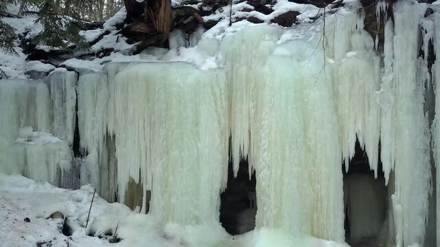 Vertical Ice Sheets Formed On The Cliffs Of Eben Ice Caves In Michigan, USA. - zoom in shot