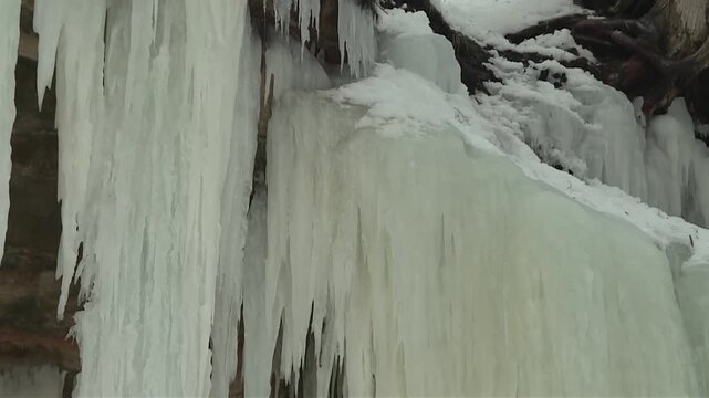 Eben Ice Caves Stalactites And Icicles In Michigan, USA. - tilt down shot