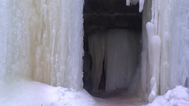 Entrance To The Eben Ice Caves With Ice Sheets Walls In Michigan, USA. - wide shot