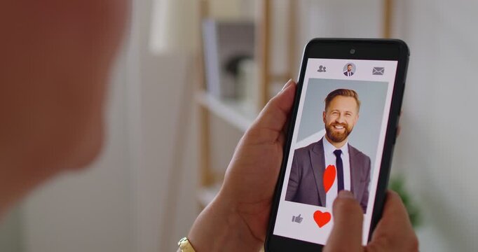 Close-up of a woman on a online dating smartphone app, checking a profile and choosing to swipe for a match, exploring love and romance on a mobile screen while online. A simple choice screen today.
