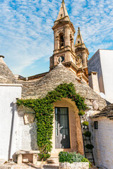 beautiful fancy buildings trulli in Puglia , Italy. Fantastic italian architecture with old houses with white walls and round conic roofs.