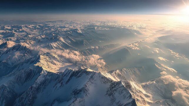 Breathtaking Aerial View of Snow Capped Mountain Peaks Bathed in Golden Sunlight with a Sea of Clouds at Dawn