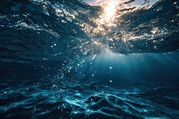 Obraz premium Underwater Sunlight Illuminating Water Surface with Bubbles and Texture Abstract Background