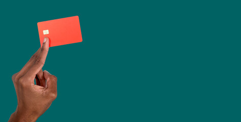 Hand holding bank card close up. African American male showing modern credit or debit card for