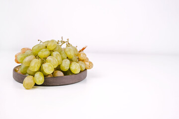 A bunch of white grapes on a table, close-up.