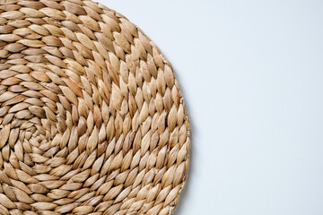 A round woven placemat made from natural water hyacinth isolated on white background