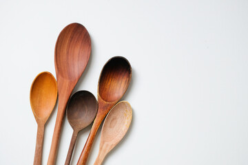 Variety of wooden spoons isolated on white background