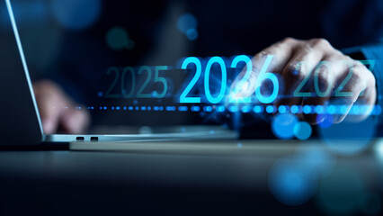2026 business planning: Annual review, goals, and strategy. Businessman on laptop working on 2025-2026 transition, forecasting future success, innovation, and digital transformation.