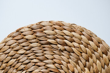 Close-up pattern of round woven placemat made from natural water hyacinth