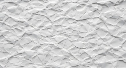 Fototapeta premium Close-up view of a crumpled white paper surface, showing intricate textures and shadows.