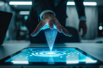 Close up of a businessman s hand interacting with a glowing blue digital hologram projected from a tablet screen in a modern office setting