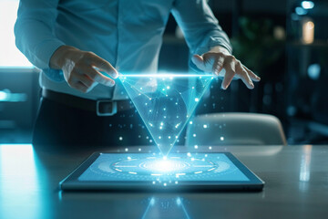 Futuristic technology concept of a person interacting with a glowing holographic display projected from a tablet computer in a modern office environment
