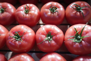 Tomatoes are collected in wooden boxes. Vegetable sale.