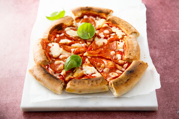 Traditional Pepperoni pizza with fresh basil